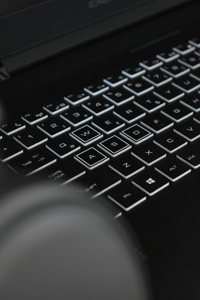 Mastering the First Impression: Your intriguing post title goes here Close-up of black keyboard with glowing keys and letters, in low light.